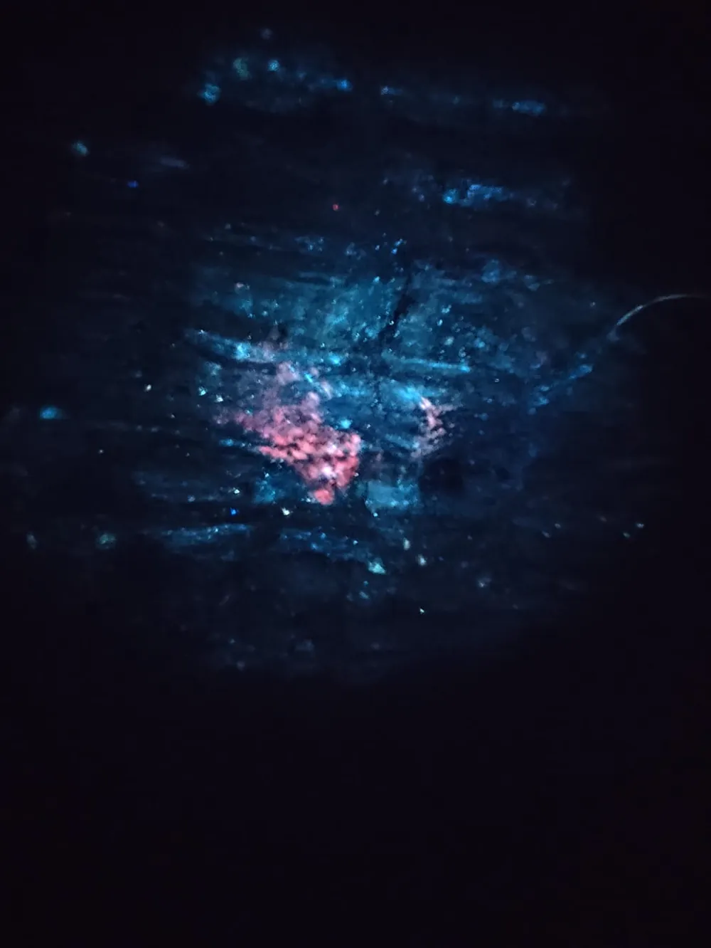 Multicolour fluorescence on pegmatite under UV light