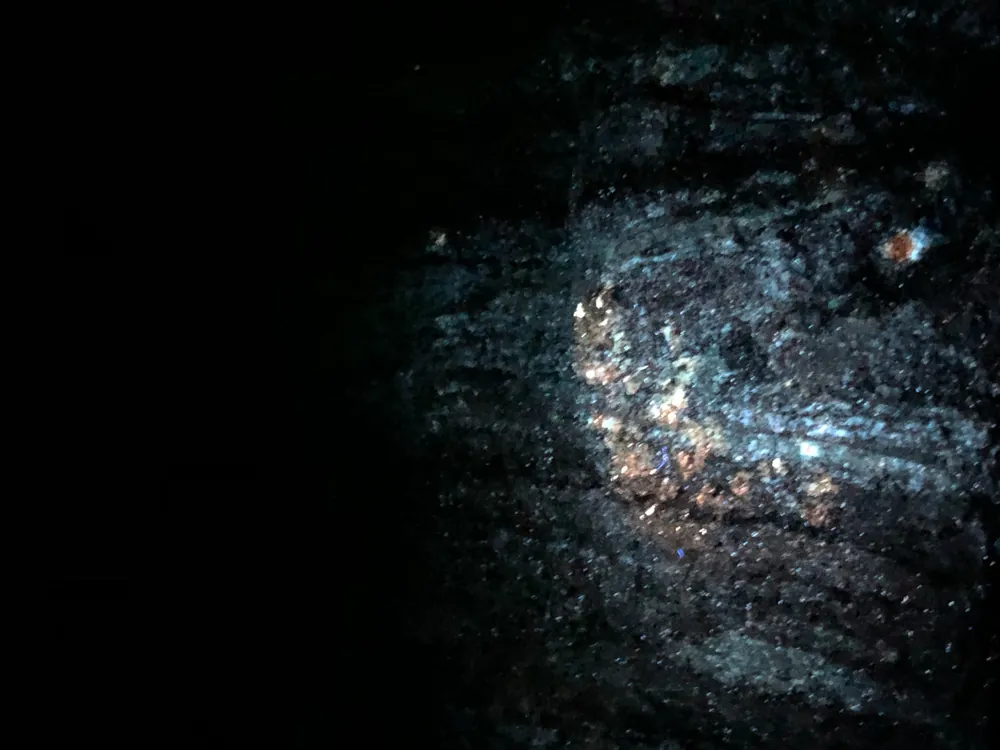 Orange fluorescence on pegmatite under UV light