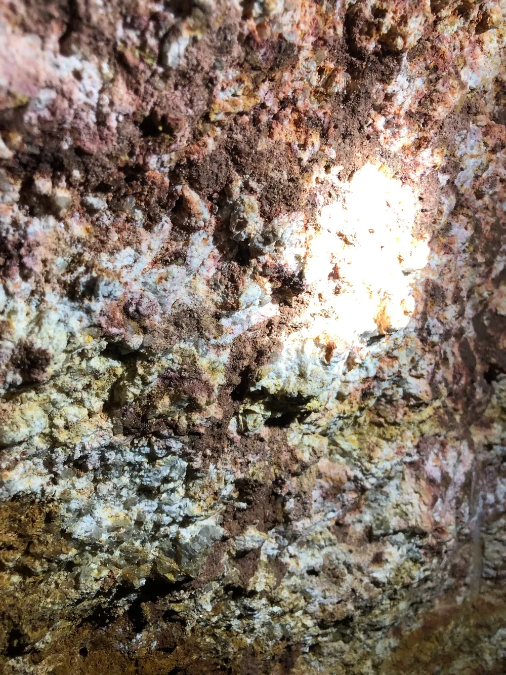 Pink saprolite in gallery with biotite and tourmaline patches