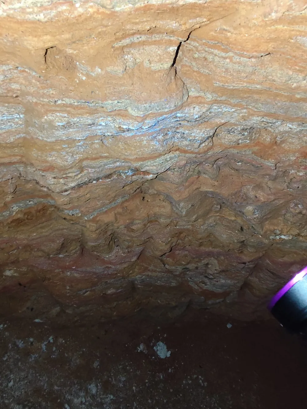 Folded, weathered pegmatitic layering in an artisanal mine