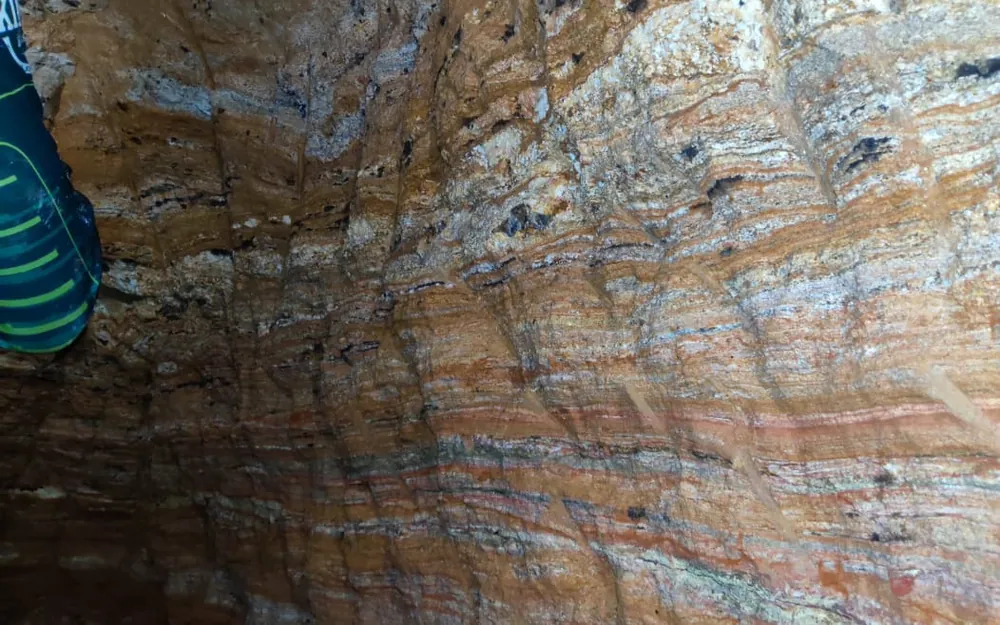 Banded pegmatitic vein with quartz, feldspar, and biotite layers