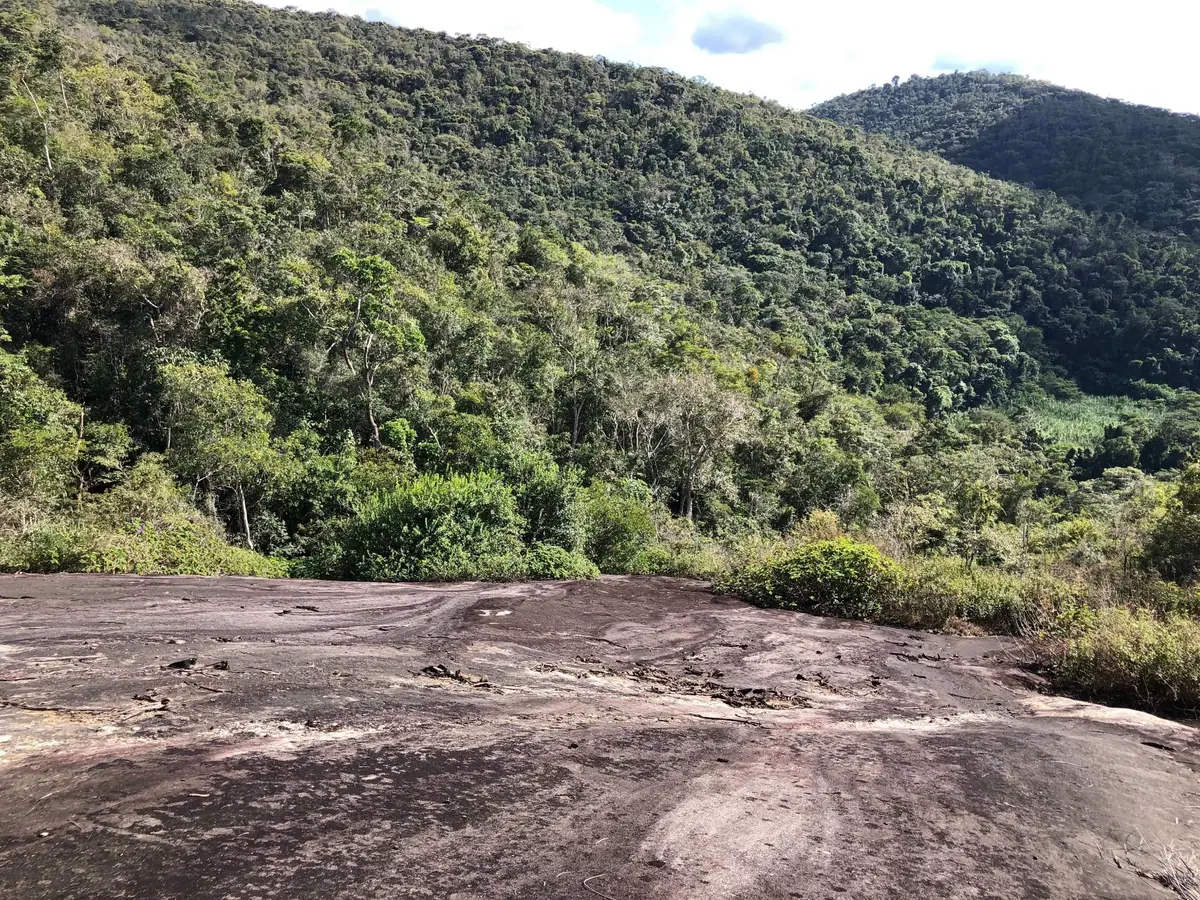 Broad granite dome exposure overlooking forested slopes in the Novo Cruzeiro region.