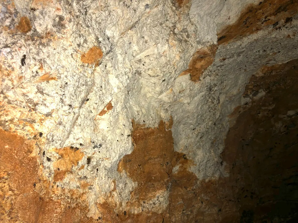 Pegmatite vein within schist host rock, exposed inside an artisanal gallery.