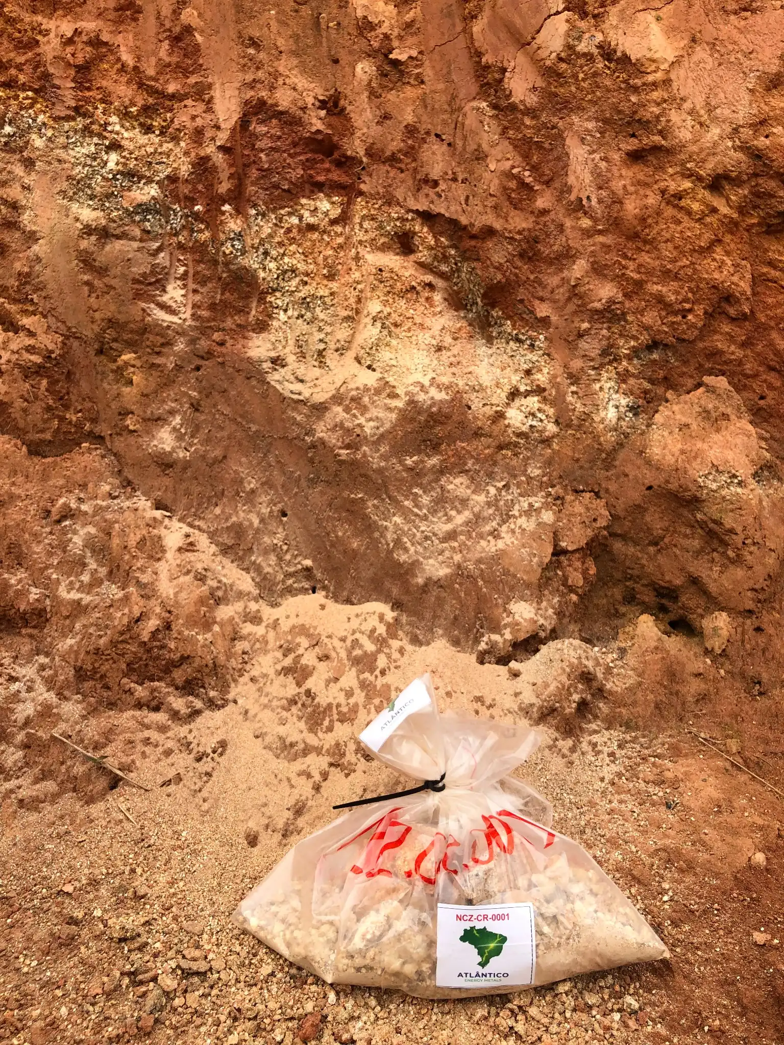 Atlantico field sample NCZ-CR-0001 beside a kaolinized saprolite roadcut.