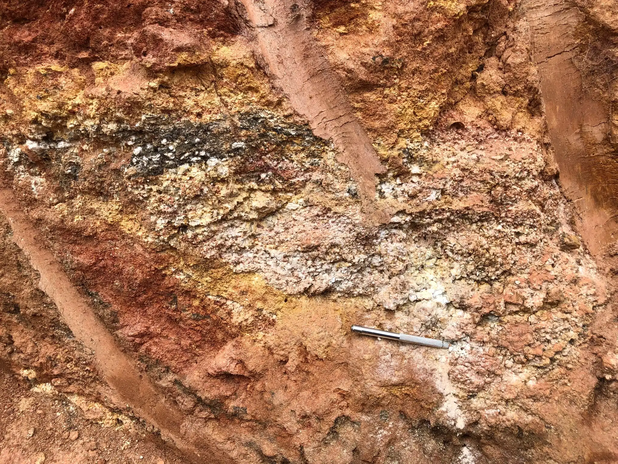 Kaolinized and iron-stained saprolite with quartz-feldspar banding