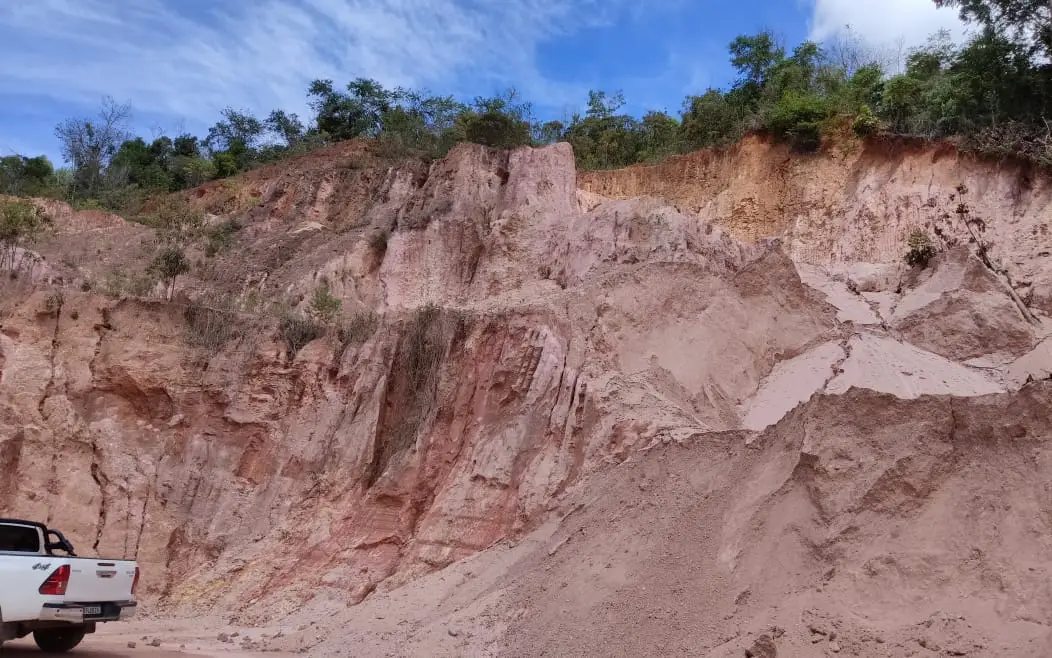 Eroded roadcut showing thick saprolitic cover over granitic rock.