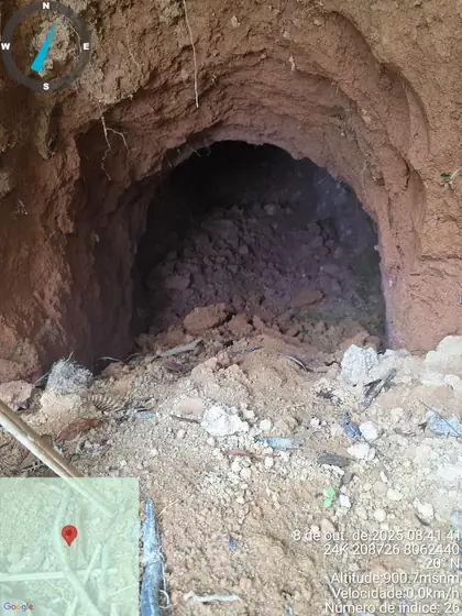 Collapsed artisanal tunnel with weathered clay-rich walls near the entrance.
