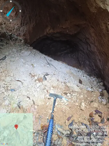 Collapsed artisanal tunnel with pale clay-rich material at the entrance.