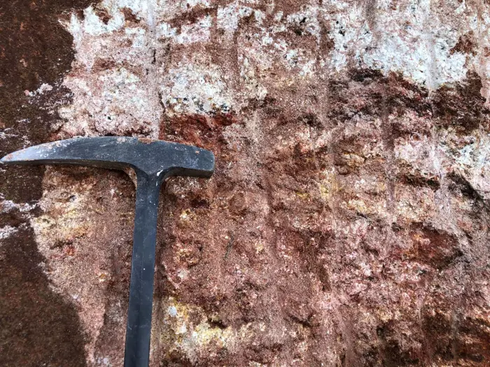 Weathered pegmatite with quartz, feldspar, and iron staining
